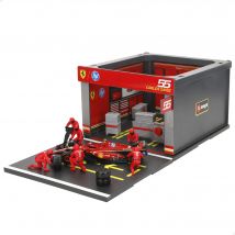 Burago - Set Box Ferrari SF23 Carlos Sainz 1:43, coche metálico die-cast, box 3D, 6 mecánicos, producto oficial Ferrari, recomendado a partir de 3 años, juguete dinámico, pieza de colección ,ideal