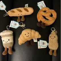 Dieser JC-Croissant-förmiger Taschenanhänger und Schlüsselanhänger ist ein perfektes Geschenk für Lebensmittelliebhaber und ein tolles Accessoire für Taschen und Telefone.