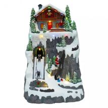 Beleuchtetes Weihnachtsdorf Skipiste mit Weihnachtsmann