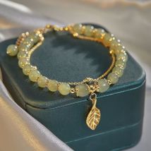 Bracelet perlé en émail de branches dorées et de feuilles de jade haut de gamme à la mode, nouveau, créatif, niche Mori, bracelet léger de luxe pour femmes
