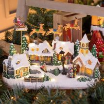 Village de Noël LED Enneigé avec Eglise Père Noël sur Traineau Volant avec Rennes en Mouvement et Musique Lotti