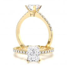 A beautiful radiant cut diamond ring with shoulder stones in 18ct yellow gold