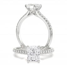 A striking radiant cut diamond ring with shoulder stones in 18ct white gold