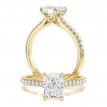 A striking radiant cut diamond ring with shoulder stones in 18ct yellow gold